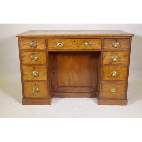 1044 - C19th faded mahogany nine drawer knee hole desk, the cupboard with two shelves, brass plate handles ... 