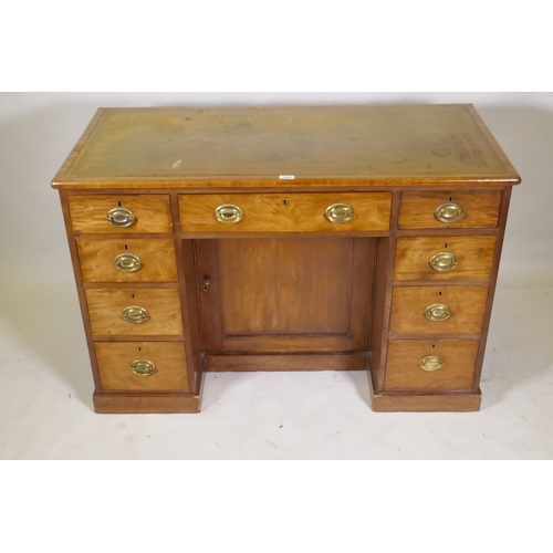 1044 - C19th faded mahogany nine drawer knee hole desk, the cupboard with two shelves, brass plate handles ... 