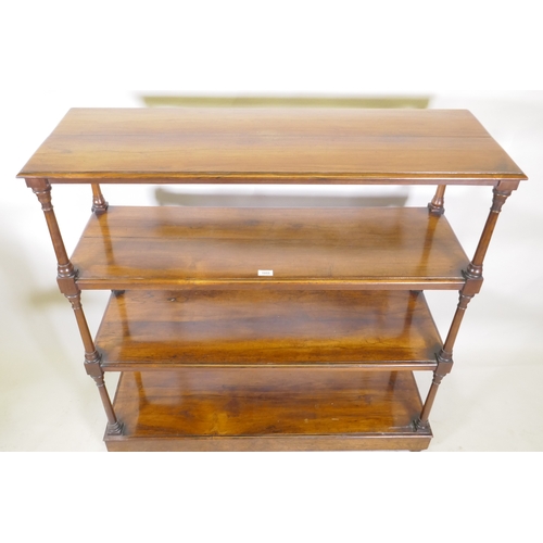 1055 - A C19th rosewood four tier buffet, raised on turned tapering columns, good faded colour, and a plint... 