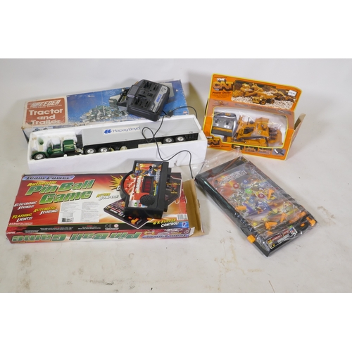 106 - Asahi radio controlled tractor and trailer, 70cm long, pin ball game and cat power dozer