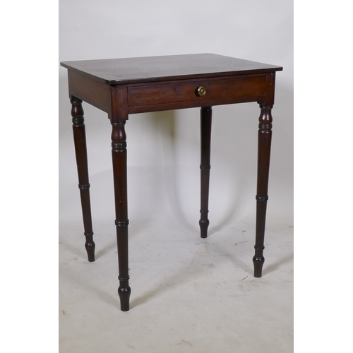 1064 - A Georgian mahogany single drawer side table, raised on ring turned tapering supports