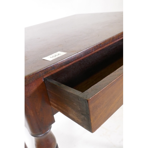 1064 - A Georgian mahogany single drawer side table, raised on ring turned tapering supports