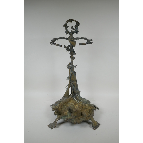 1067 - An antique French brass stick stand with game hunting decoration, 56cm high