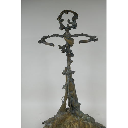 1067 - An antique French brass stick stand with game hunting decoration, 56cm high