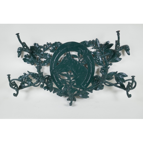 1068 - A painted cast iron coat rack with equestrian decoration, 76 x 40cm