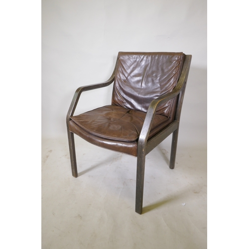 1069 - A laminated open elbow chair with brown leather seat pad and back