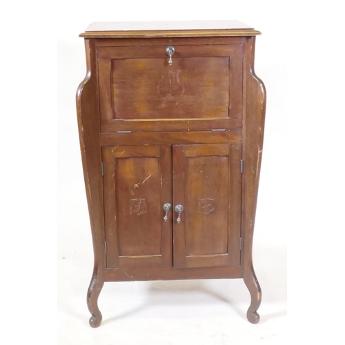 1070 - An early C20th Art Nouveau style mahogany music cabinet, with fall front and two cupboards, 55 x 44 ... 