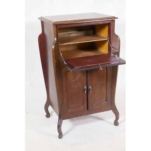 1070 - An early C20th Art Nouveau style mahogany music cabinet, with fall front and two cupboards, 55 x 44 ... 