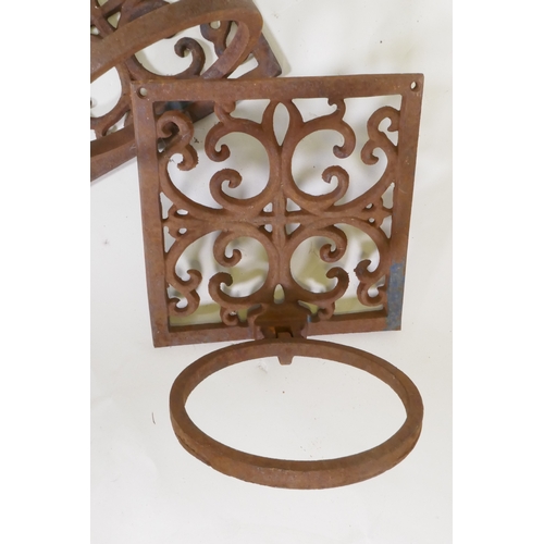 1074 - A pair of cast iron wall brackets with fold down pot holders, 19 x 19 x 19cm