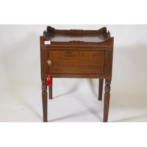 1077 - A Georgian mahogany pot cupboard, with carved galleried top, single door, raised on turned supports,... 