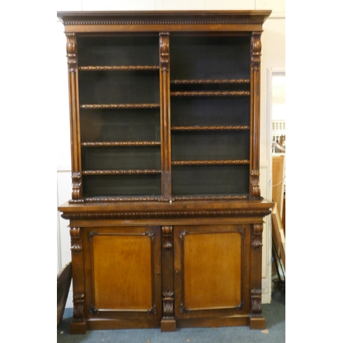 1079 - A William IV rosewood and mahogany bookcase in two parts, the upper with open shelves, the lower wit... 