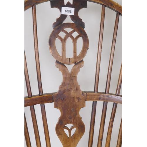 1088 - A C19th yew wood hoop back elbow chair with pierced splat and elm seat, back legs and stretchers, AF