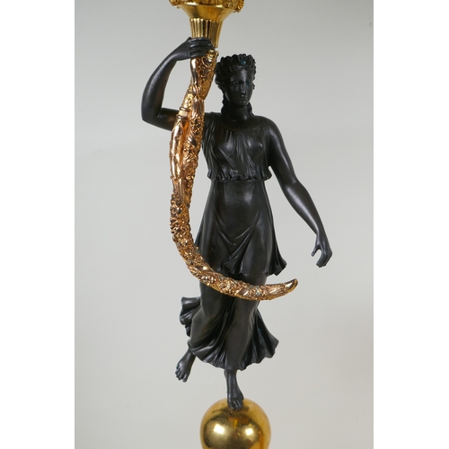 109 - A pair of Regency style bronze and ormolu four branch candelabra in the form of classical women hold... 