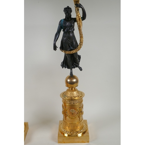 109 - A pair of Regency style bronze and ormolu four branch candelabra in the form of classical women hold... 