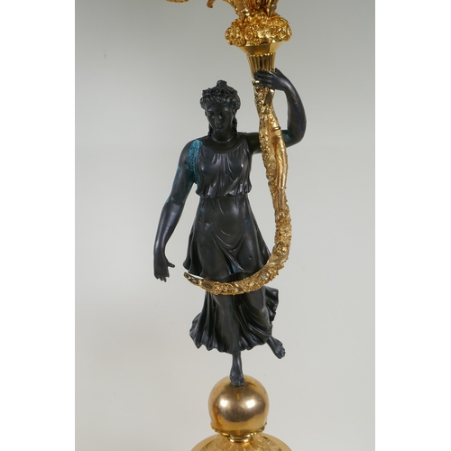 109 - A pair of Regency style bronze and ormolu four branch candelabra in the form of classical women hold... 