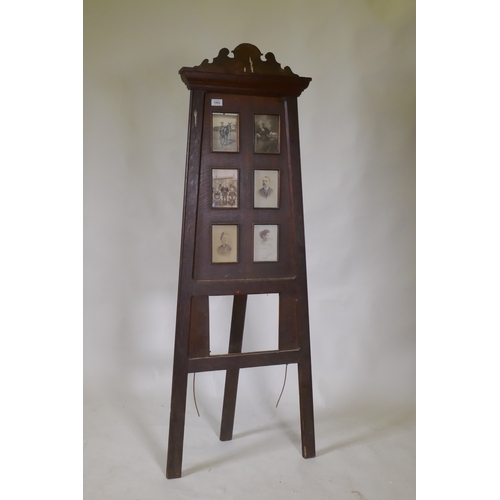 1093 - A Victorian oak easel photo frame, 152cm high