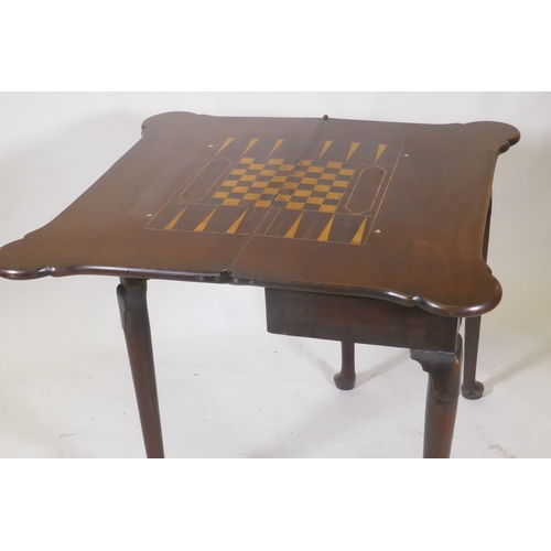 1094 - A Georgian mahogany fold over tea table with inlaid games top, shaped top and frieze drawer, raised ... 