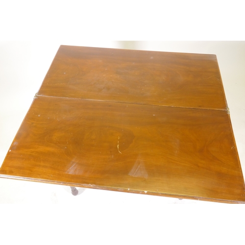 1097 - A Georgian mahogany fold over tea table, with single drawer and swan neck handles, raised on fluted ... 