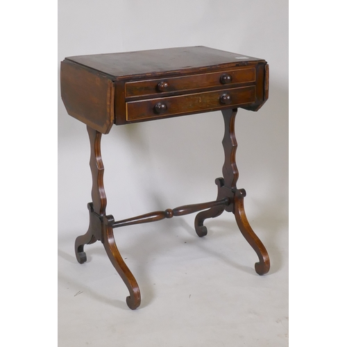 1098 - A Georgian rosewood work table with drop flaps and two drawers, raised on shaped end supports united... 