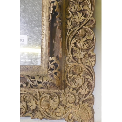 1103 - An antique Indian carved and gilt mirror with pierced details, 47 x 68cm