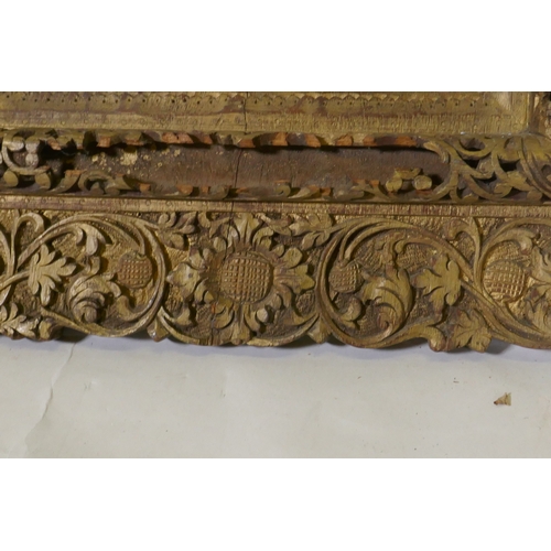 1103 - An antique Indian carved and gilt mirror with pierced details, 47 x 68cm