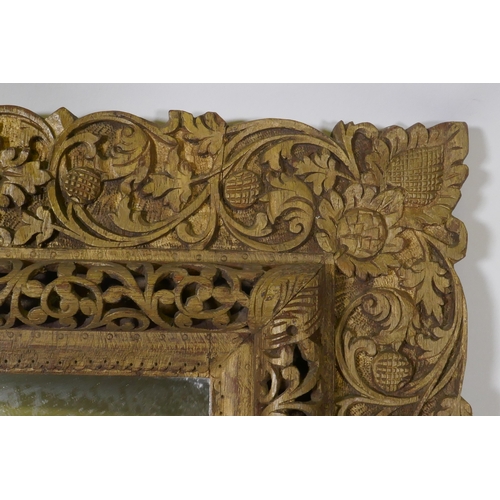 1103 - An antique Indian carved and gilt mirror with pierced details, 47 x 68cm