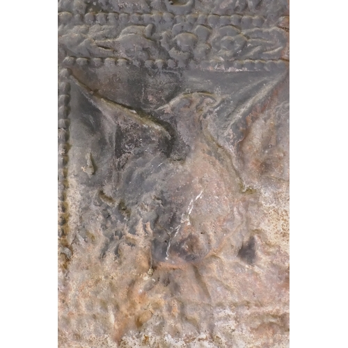 1109 - A cast iron fire back with raised decoration of a phoenix rising from the flames, 44 x 58cm