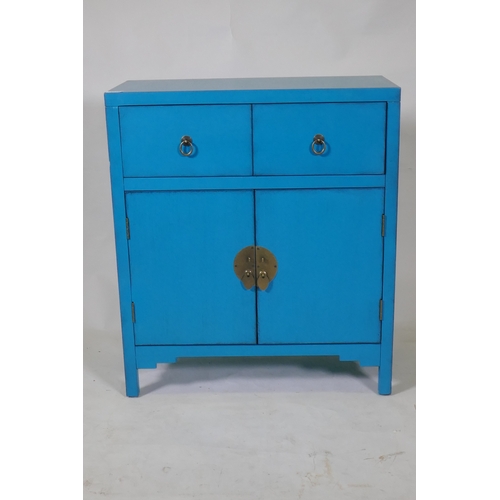 1110 - A contemporary oriental style lacquered cabinet with two drawers over two cupboards, 66 x 32 x 76cm