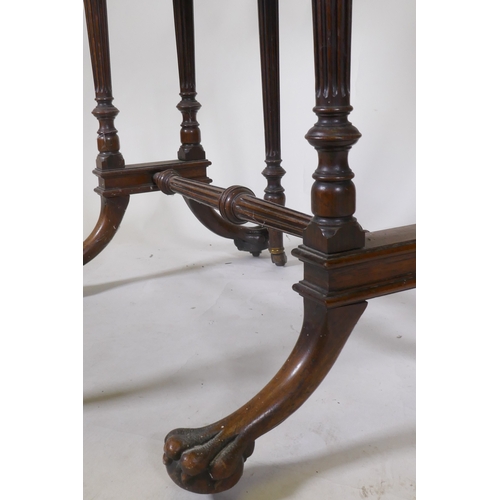 1111 - A fine C19th rosewood Sutherland table, raised on fluted tapering columns and swept supports with pa... 