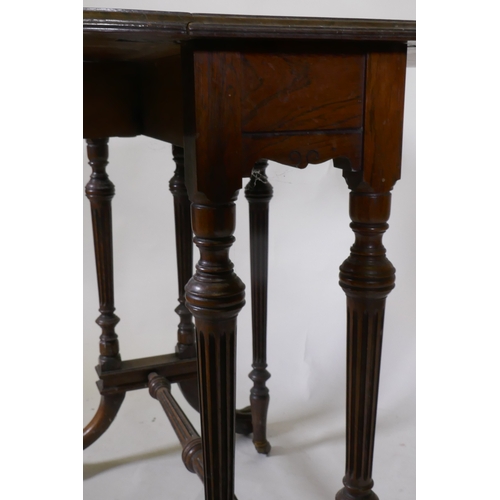 1111 - A fine C19th rosewood Sutherland table, raised on fluted tapering columns and swept supports with pa... 