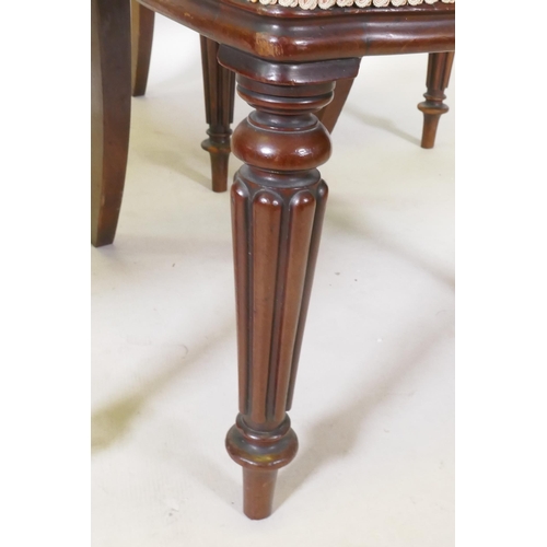 1122 - Set of four C19th mahogany kidney back chairs raised on turned reeded supports, stamped James Winter... 