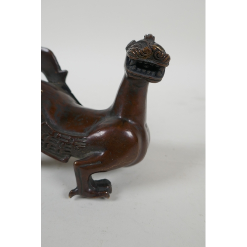 113 - A Japanese filled bronze stylised dragon, 21cm long, indistinct 6 character mark to base