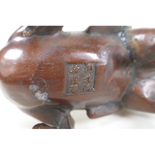 113 - A Japanese filled bronze stylised dragon, 21cm long, indistinct 6 character mark to base