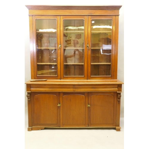 1130 - A C19th French stained fruitwood and walnut bookcase, the upper section with two glazed doors, fitte... 