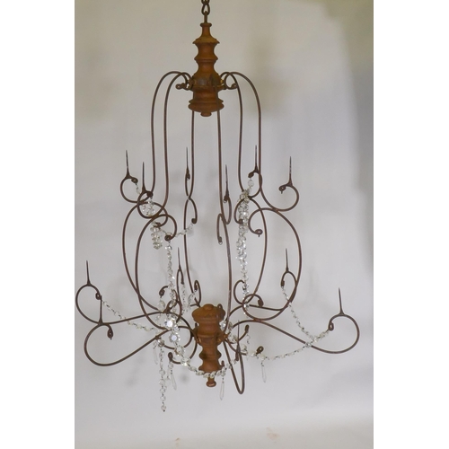 1149 - A wrought iron and pine six branch chandelier, with twelve candle prickets and glass lustre swags, 9... 