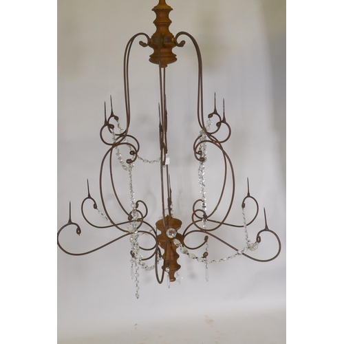 1149 - A wrought iron and pine six branch chandelier, with twelve candle prickets and glass lustre swags, 9... 