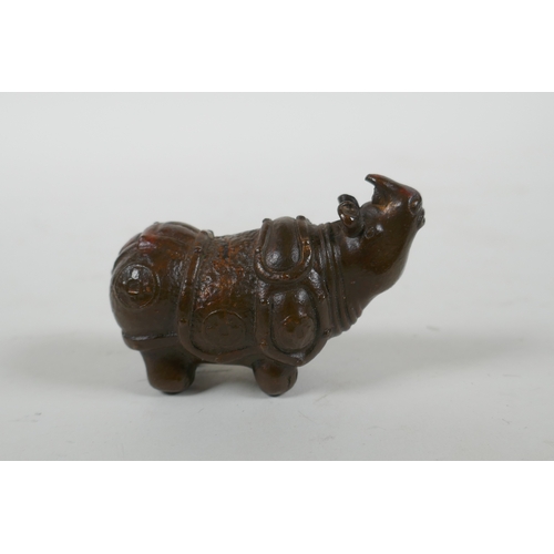 115 - A Japanese style bronze okimono rhinoceros, 6.5cm long