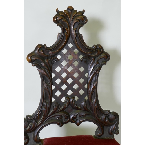 1151 - A C19th Chippendale style walnut hall chair, with carved and pierced trellis back, raised on cabriol... 