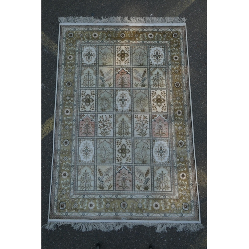 1159 - An ivory ground silk Kashan rug with panelled garden design, signed, 126 x 184cm