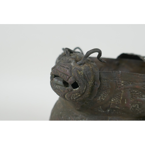 116 - A Nepalese copper pot decorated with four tiger masks and repousse decoration of snakes and suns, 15... 