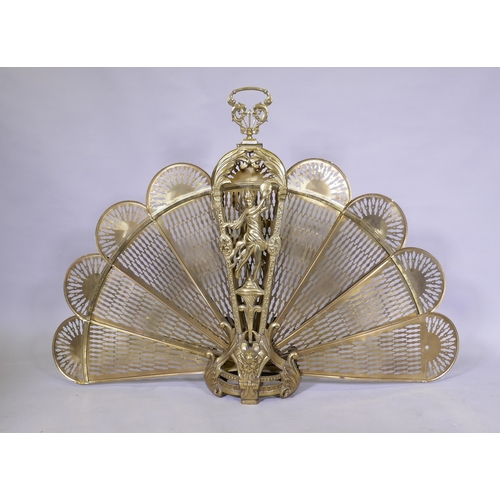 1160 - A brass fan shaped fire guard, handle detached and retaining clip, AF, 125 x 87cm