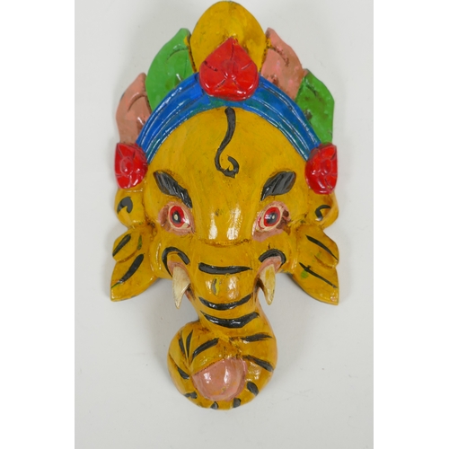 118 - An Indian carved and painted wood Ganesh wall mask and another carved and gilt Buddha mask, largest ... 