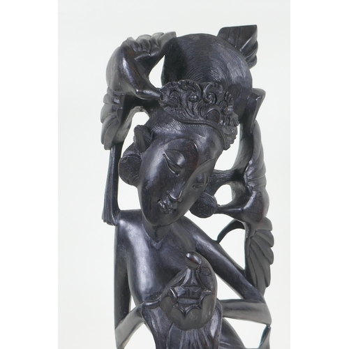 119 - A Balinese carved ebony figure of a dancer, 45cm high