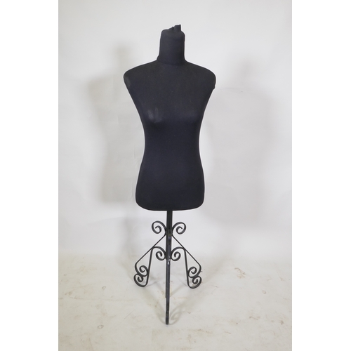 126 - A shop mannequin on a painted metal tripod base, 122cm high