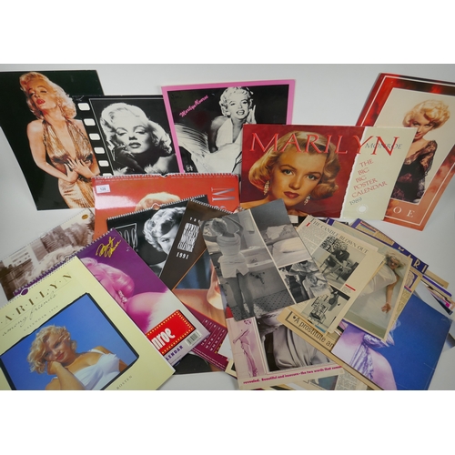 128 - A large quantity of Marilyn Monroe ephemera to include calendars, press cuttings and posters, larges... 