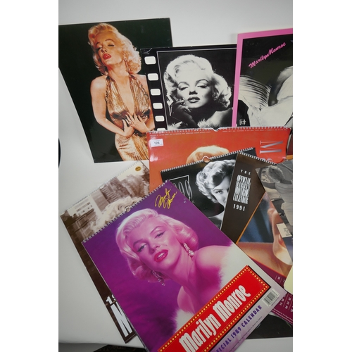 128 - A large quantity of Marilyn Monroe ephemera to include calendars, press cuttings and posters, larges... 