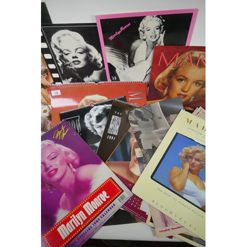 128 - A large quantity of Marilyn Monroe ephemera to include calendars, press cuttings and posters, larges... 