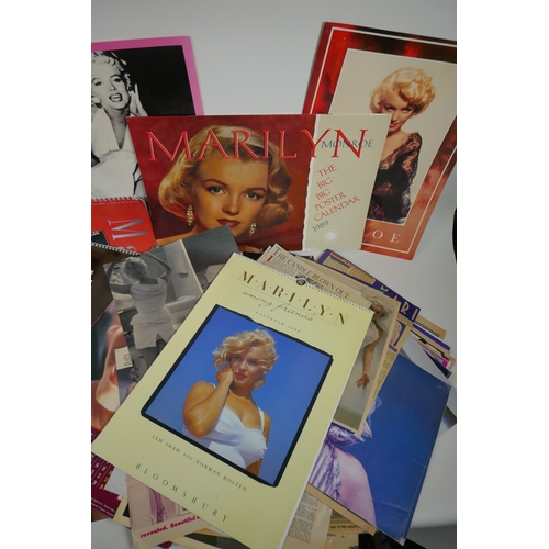 128 - A large quantity of Marilyn Monroe ephemera to include calendars, press cuttings and posters, larges... 