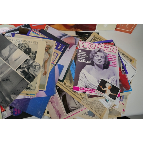 128 - A large quantity of Marilyn Monroe ephemera to include calendars, press cuttings and posters, larges... 