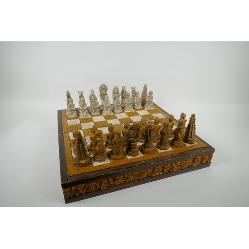 133 - A composition chess set in the form of Myan deities, complete, 40 x 40cm